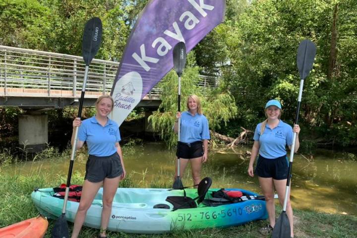 a group of people that are standing in the grass